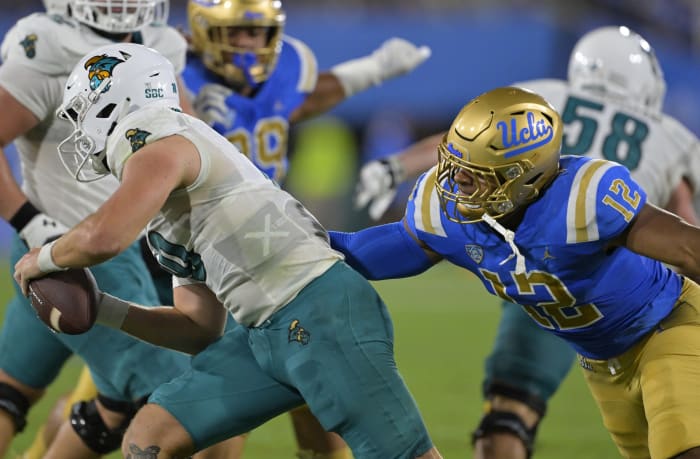 Sep 2, 2023; Pasadena, California, USA; UCLA Bruins defensive lineman Grayson Murphy (12) pressures Coastal Carolina Chanticleers quarterback Grayson McCall (10) in the first half at Rose Bowl. Mandatory Credit: Jayne Kamin-Oncea-USA TODAY Sports